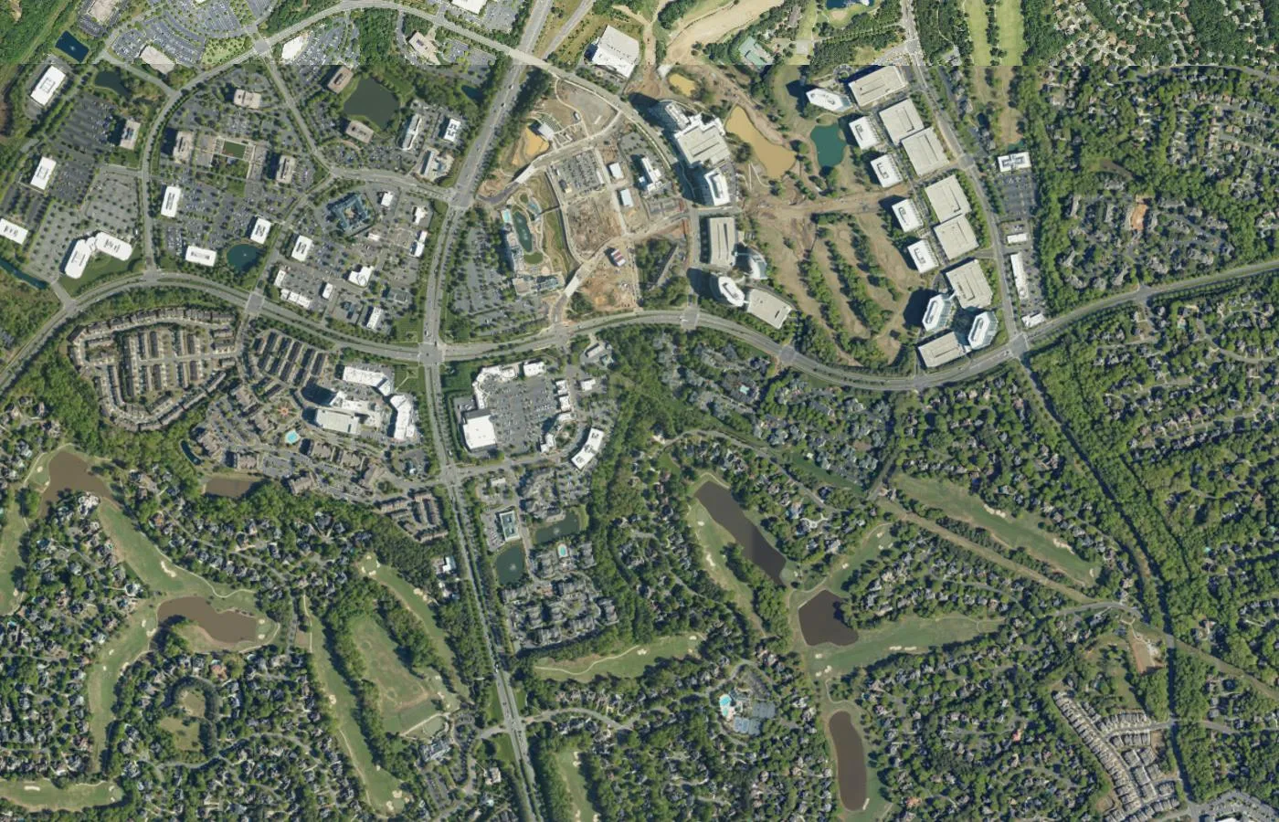Aerial view of wooded neighborhoods and roads in south Charlotte